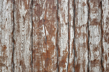 Aged wooden background of boards with cracked and brown peeling paint.
