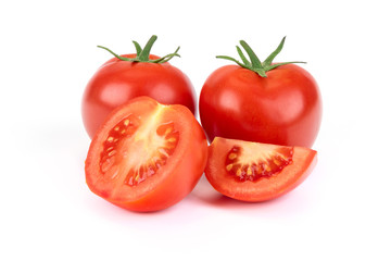 Group of whole and sliced tomatoes isolated on a white background in close-up