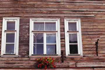 three white wooden window frames and flower box