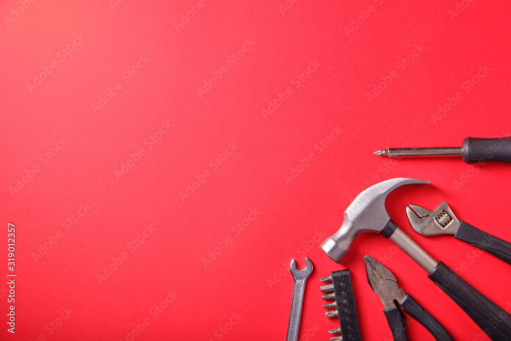 Wall mural tools on a red background, a hammer, a place for an inscription