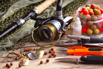 fishing tackle on a wooden table. toned image