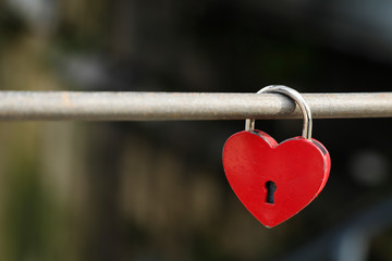 Red heart lock as a symbol for love like valentines day or wedding, space for text, nobody and horizontal