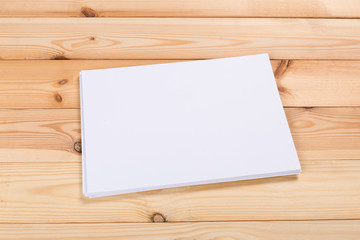 white paper on wood background and shadow