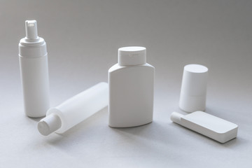 A compilation of white plastic cosmetic containers for body and face care
