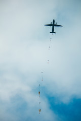 Army paratroopers jumping at air war action.