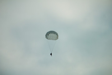 Army paratroopers jumping at air war action.