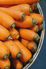 Fresh orange carrots for sale at a farmers market