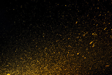 Fototapeta na wymiar Golden dots of paint on a black background. Abstract background. Web banner.