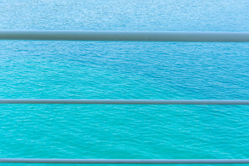 Sea for background in beautiful color of aqua menthe. With three white lines in front of it. Beautiful and calm photo. 