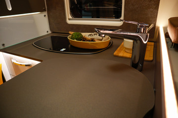 Interior of luxury caravan. Detail photo of coach with equipment.Kitchen