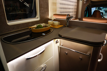 Interior of luxury caravan. Detail photo of coach with equipment.Kitchen