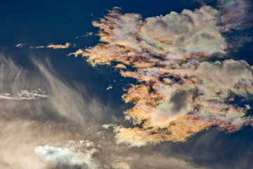 contrasting clouds reflect bright sunlight. bright sky at noon.