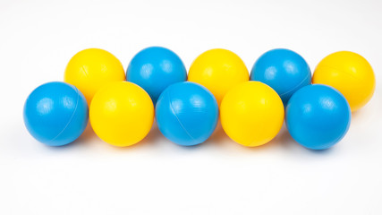 Colored plastic balls on white background. leisure and game items. round objects