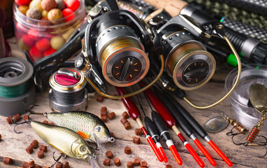 fishing tackle on a wooden table. toned image