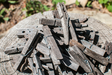 Pile of weathered wooden laundry clamps closeup