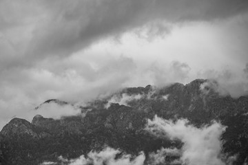 Black and white photography of cloudy stormy sky over mountains. Rainy weather. Turkey. Horizontal color photography.