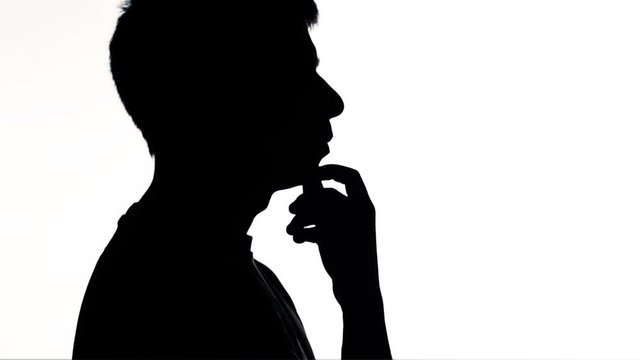 silhouette of young man thinking and reasoning , male seeking a solution of problem, concept of people feelings and life