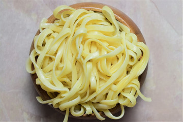 Pasta de tallarines en bol de madera