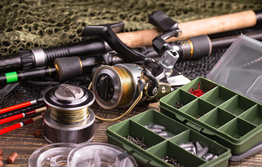 fishing tackle on a wooden table. toned image