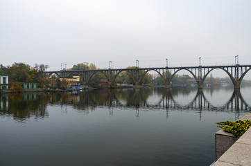 Single-track railway arch bridge in fog