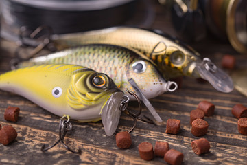 fishing tackle on a wooden table. toned image