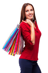 Portrait of young happy smiling pretty woman with shopping bags, isolated over white background.