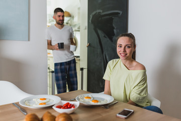 happy romantic couple having breakfast at home
