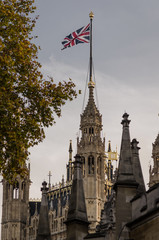 Gothic architectural style tower waving the flag of the United Kingdom