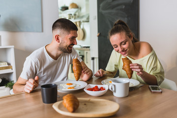 happy romantic couple having breakfast at home