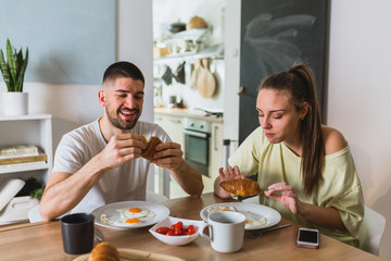 happy romantic couple having breakfast at home