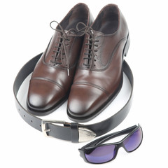 Classic men's shoes, belt and glasses on white background