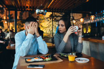 couple arguing in restaurant. relationship problems