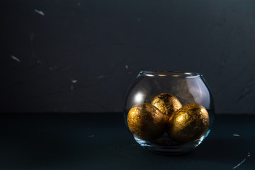 gold eggs on blue concrete background. Happy easter concept