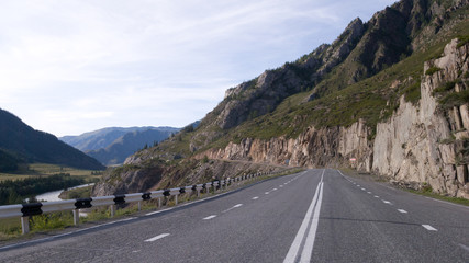 Beautiful smooth asphalt road in the mountains. Marking on a country road. It's a lonely road without cars