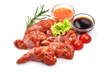 Raw chicken legs in a barbecue marinade, isolated on white background