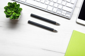 White desk office with laptop, smartphone and other work supplies with cup of coffee. Top view with...