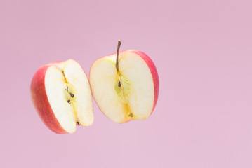 Apple cut into two halves.