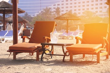 Beach landscape. Deck chairs on the sand in Dubai.
