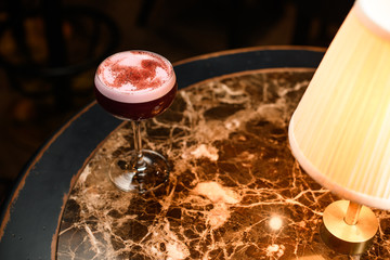 Sprinkled alcohol cocktail standing on beautiful table