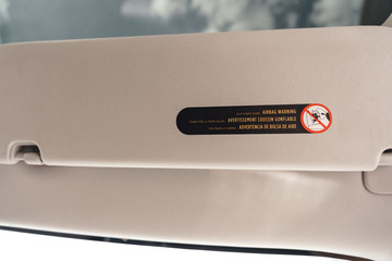Transportation. Airbag warning close-up isolated on gray