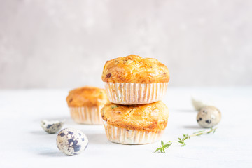 Savory muffins with bacon, quail egg, green onion and cheese on a light stone background. Protein breakfast. Paleo or keto diet.