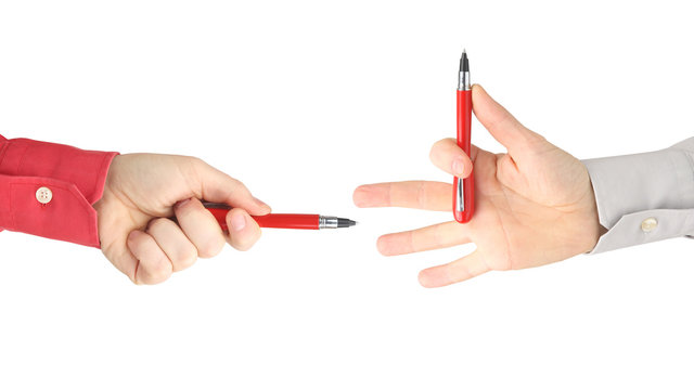 Two Hands With Red Writing Pens Facing Each Other On White Background