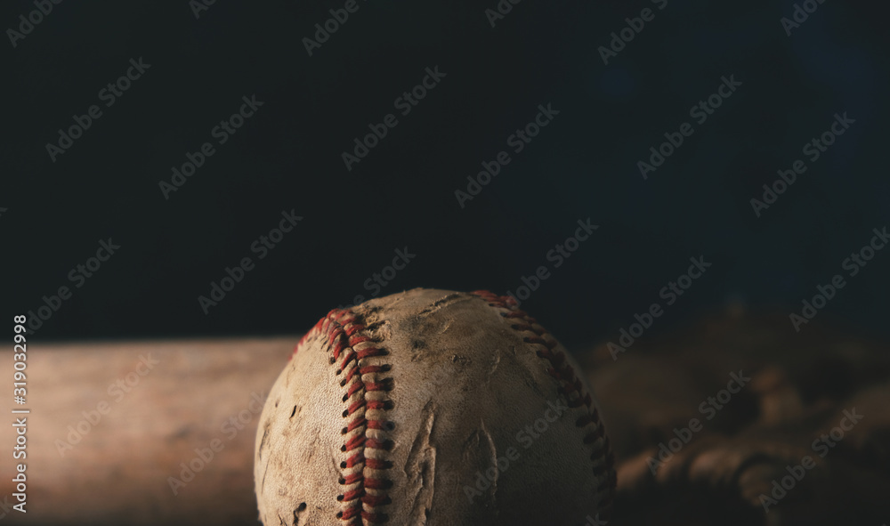Poster Moody baseball concept with old used ball and bat closeup on black background with copy space or room for text. - Posters