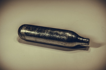 Aluminium gas Co2 cartridge for air gun isolated vintage sepia style