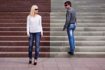 Fototapeta na wymiar Young fashion couple flirting on city street