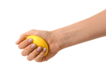 Hand squeezing stress ball on white background