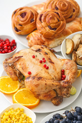Tasty baked turkey and different food for Thanksgiving day on table