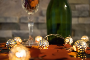 Obraz na płótnie Canvas Paper hearts, glass of champagne, bottle on the stone background.