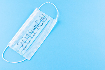 Novel coronavirus - 2019-nCoV. Protective medical mask with 2019-nCoV text. Chinese coronavirus outbreak. MERS-Cov middle East respiratory syndrome coronavirus. Blue background. Copy space