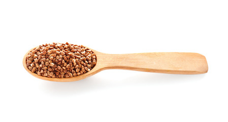 Spoon with raw buckwheat on white background